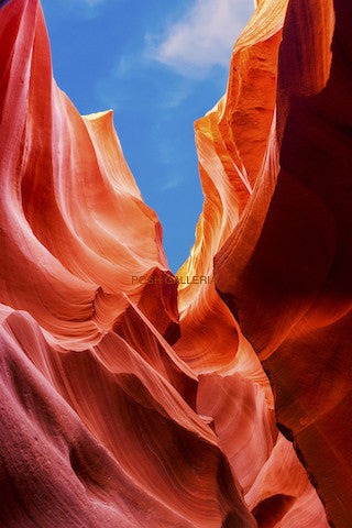 RED DESERT CAVERN WITH BRIGHT BLUE SKY